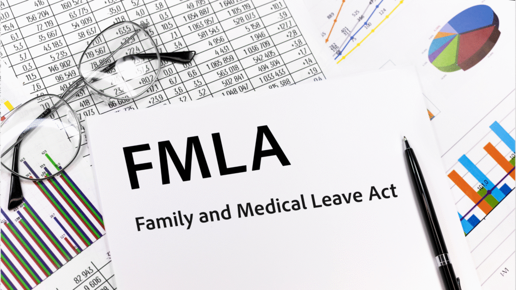 FMLA paperwork with eyeglasses, pen, and data charts on a desk